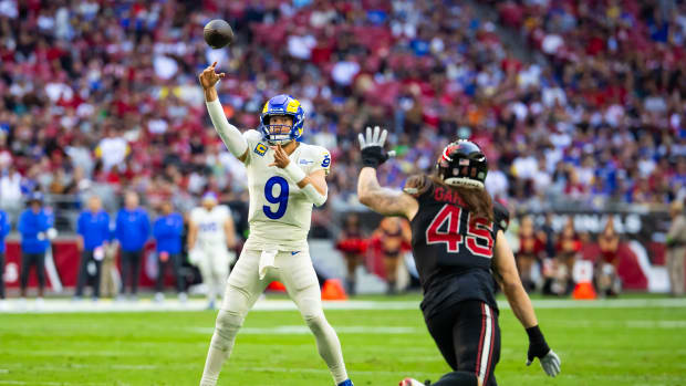 Nov 26, 2023; Glendale, Arizona, USA; Los Angeles Rams quarterback Matthew Stafford (9) throws a touchdown pass against the Arizona Cardinals in the first half at State Farm Stadium. Mandatory Credit: Mark J. Rebilas-USA TODAY Sports